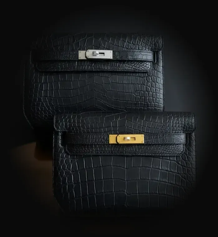Two black crocodile Hermès Kelly Dépêches pouches with palladium and gold hardware